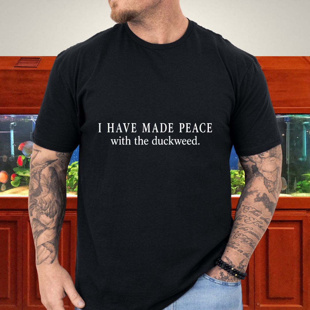 Single-ink typography reading I have made peace with the duckweed on a unisex t-shirt