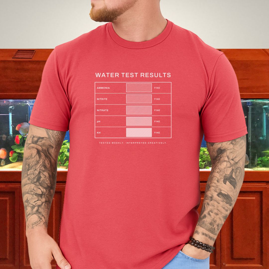 Line-art water test comparison card design (ammonia, nitrite, nitrate, pH, KH) on a black unisex t-shirt
