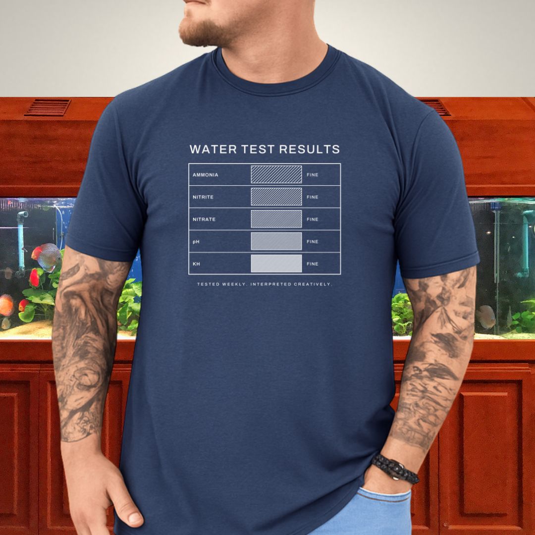Line-art water test comparison card design (ammonia, nitrite, nitrate, pH, KH) on a heather navy unisex t-shirt